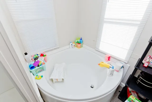 a bathroom with a sink a toilet and a window