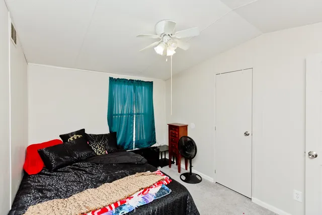 a bedroom with bed and a window