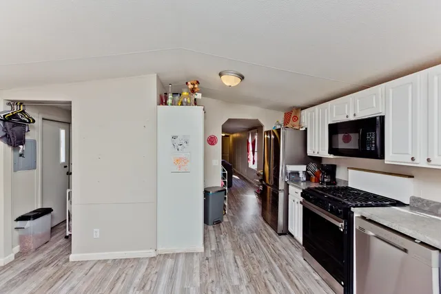 a kitchen with a refrigerator and a stove top oven