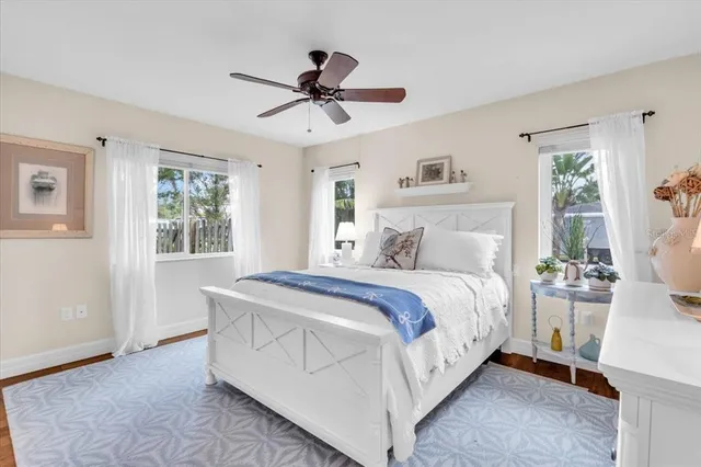 a spacious bedroom with a bed and a chandelier