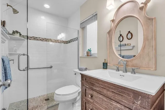 a bathroom with a sink a toilet and a mirror