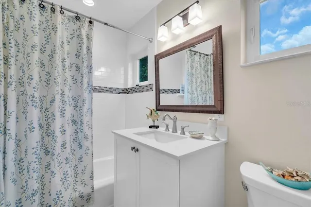 a bathroom with a sink a toilet and mirror