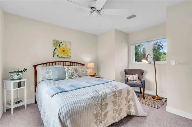 a bedroom with a bed and a painting on the wall