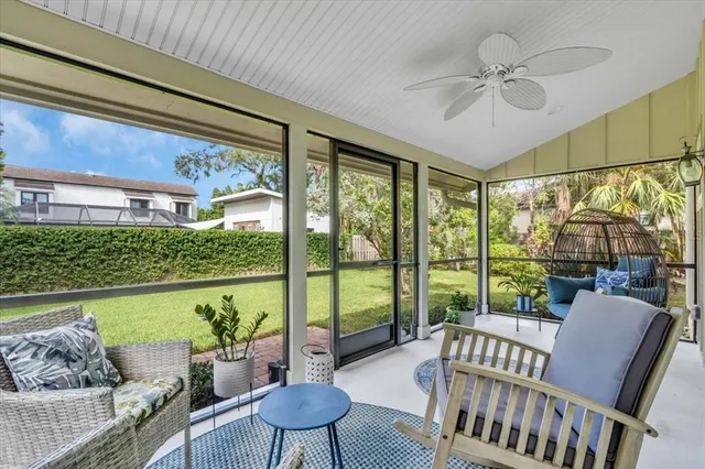 a living room with furniture and a floor to ceiling window