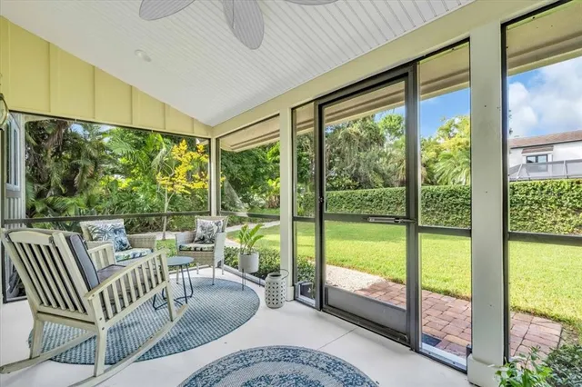 a living room with furniture and floor to ceiling windows