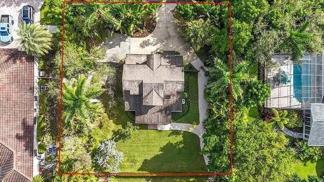 an aerial view of a house with a yard