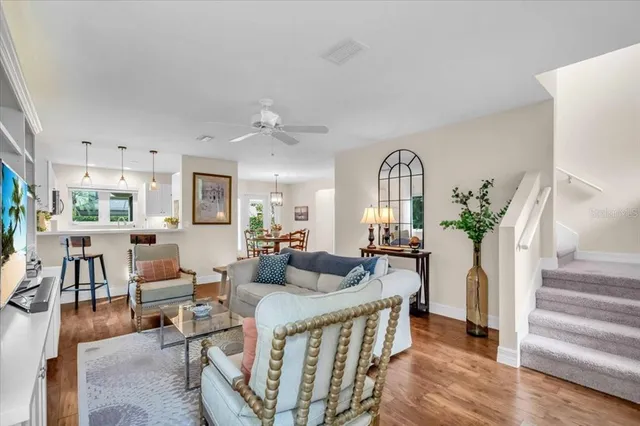 a living room with furniture fireplace and wooden floor