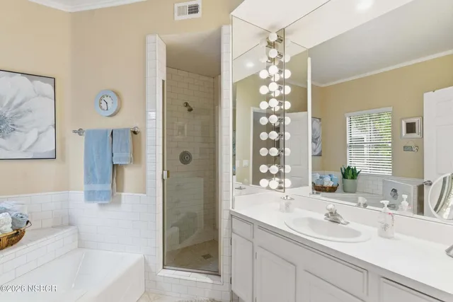 a bathroom with a sink tub shower and a mirror