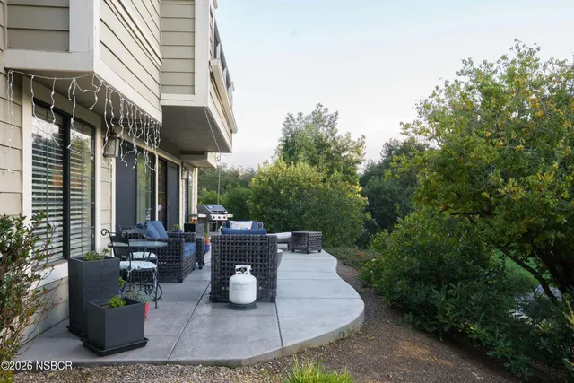a view of a patio with table and chairs and potted plants
