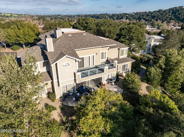 an aerial view of a house with a yard