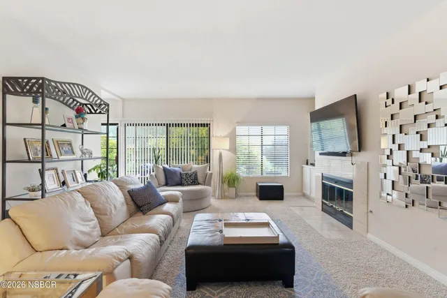 a living room with furniture flat screen tv and a fireplace