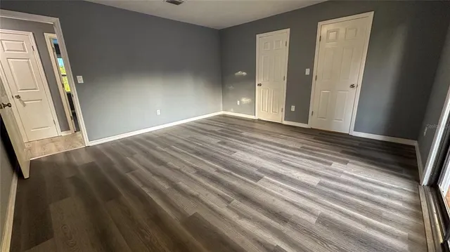 a view of an empty room and wooden floor