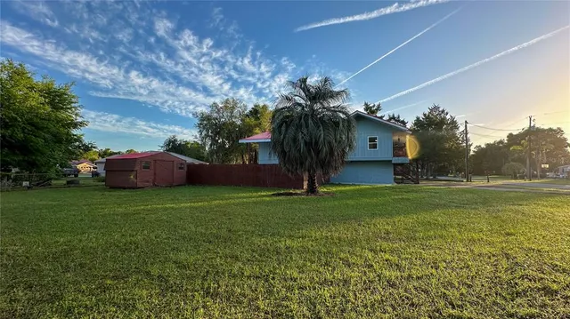 a view of a house with a yard and sitting area