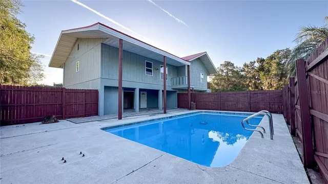 a view of a house with wooden fence