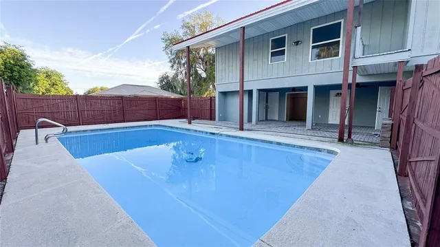 a view of a house with swimming pool in front of it