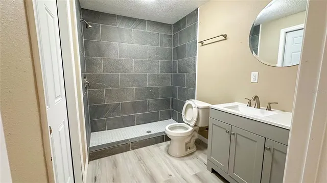 a bathroom with a sink toilet and shower
