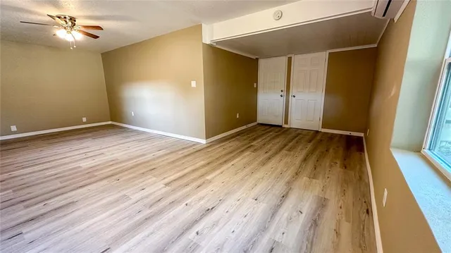 wooden floor in an empty room with a fireplace