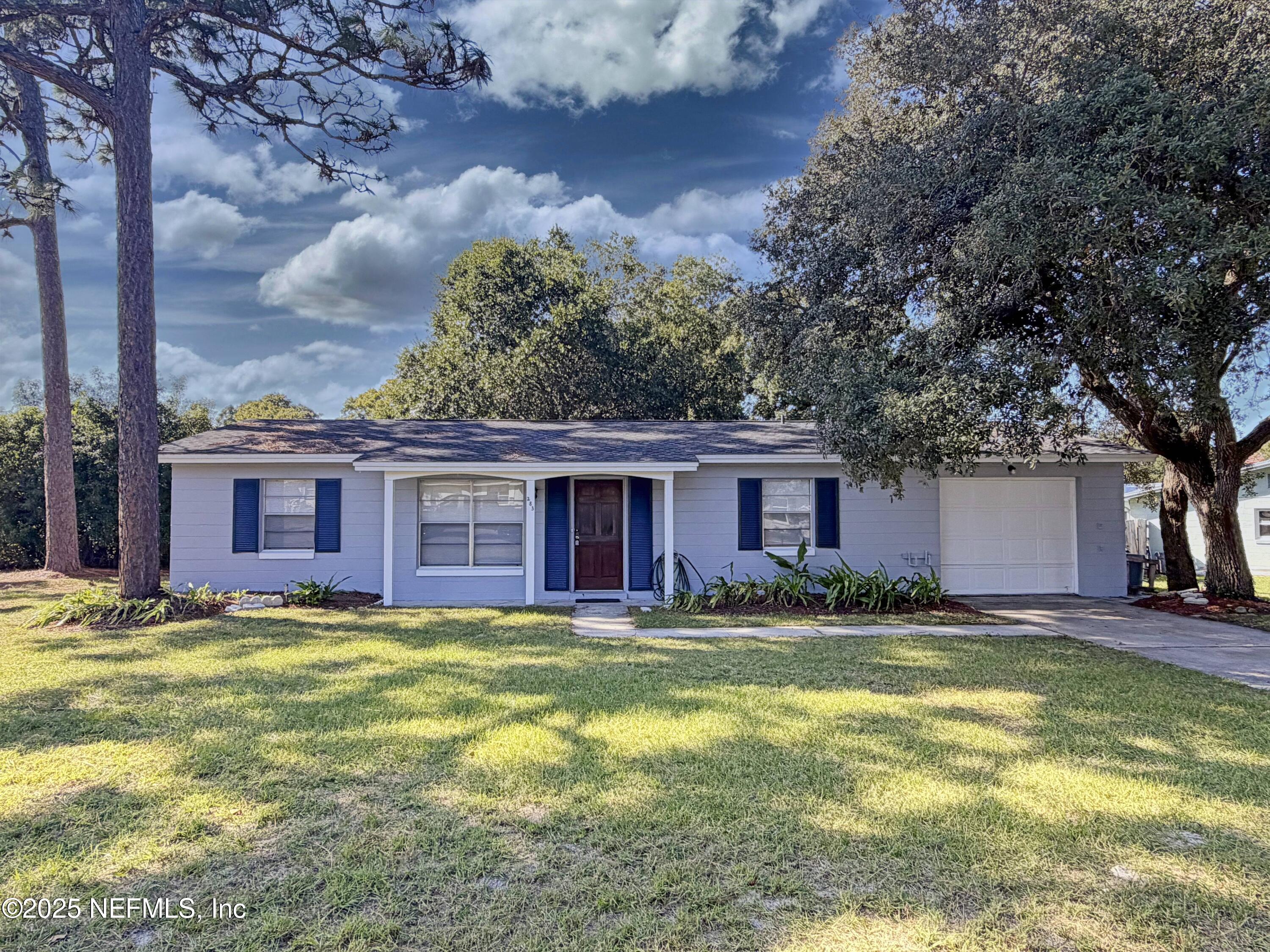 a view of a house with a yard