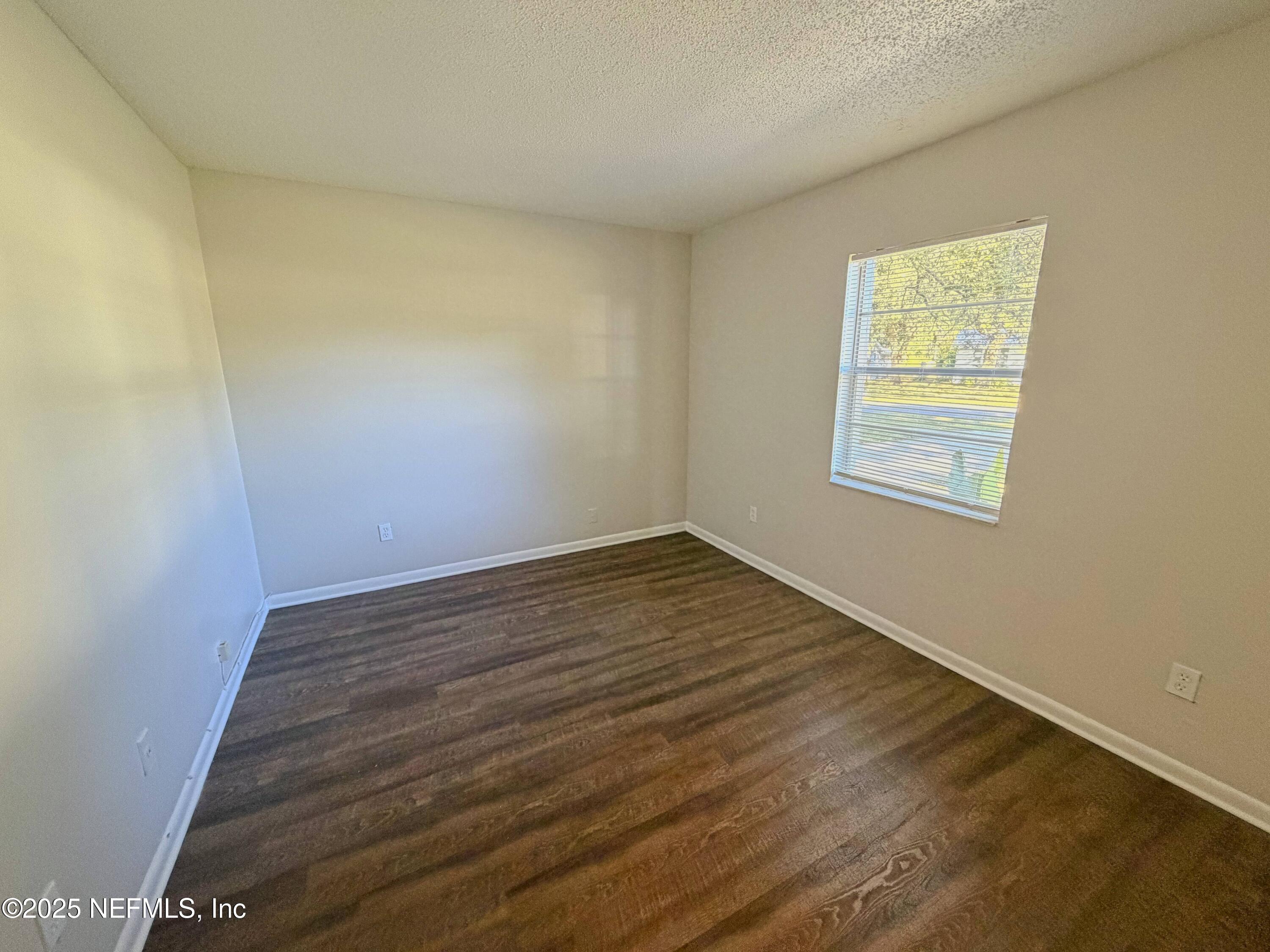 283 Almansa Road St. Augustine, FL 32086 - Photo 11 of 16 a view of an empty room with wooden floor and a window