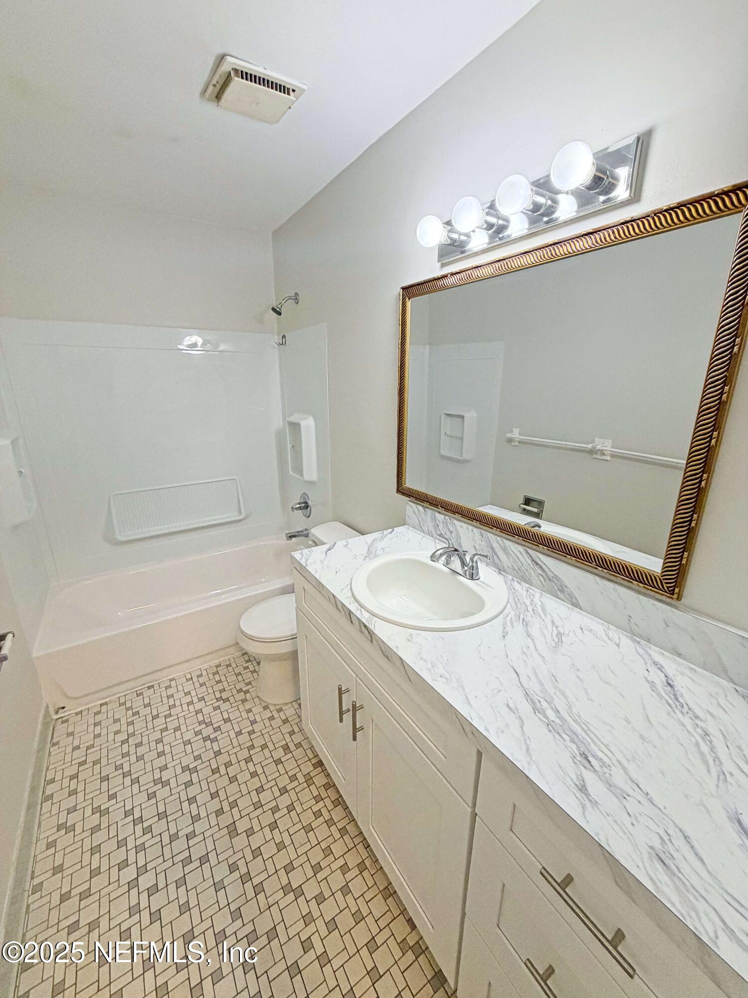283 Almansa Road St. Augustine, FL 32086 - Photo 12 of 16 a bathroom with a sink a toilet and shower