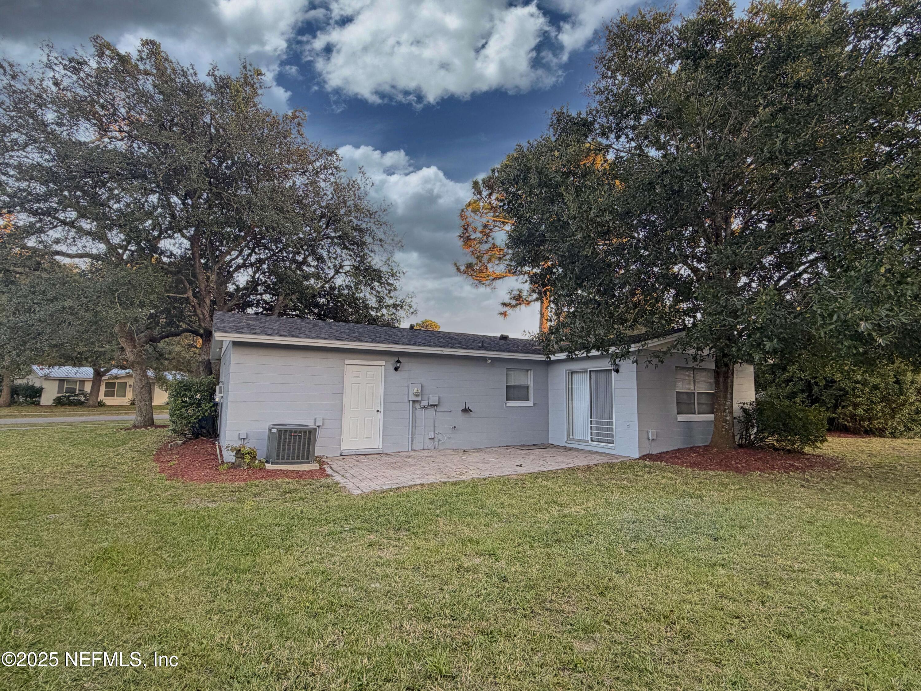 283 Almansa Road St. Augustine, FL 32086 - Photo 15 of 16 a front view of house with yard and trees around