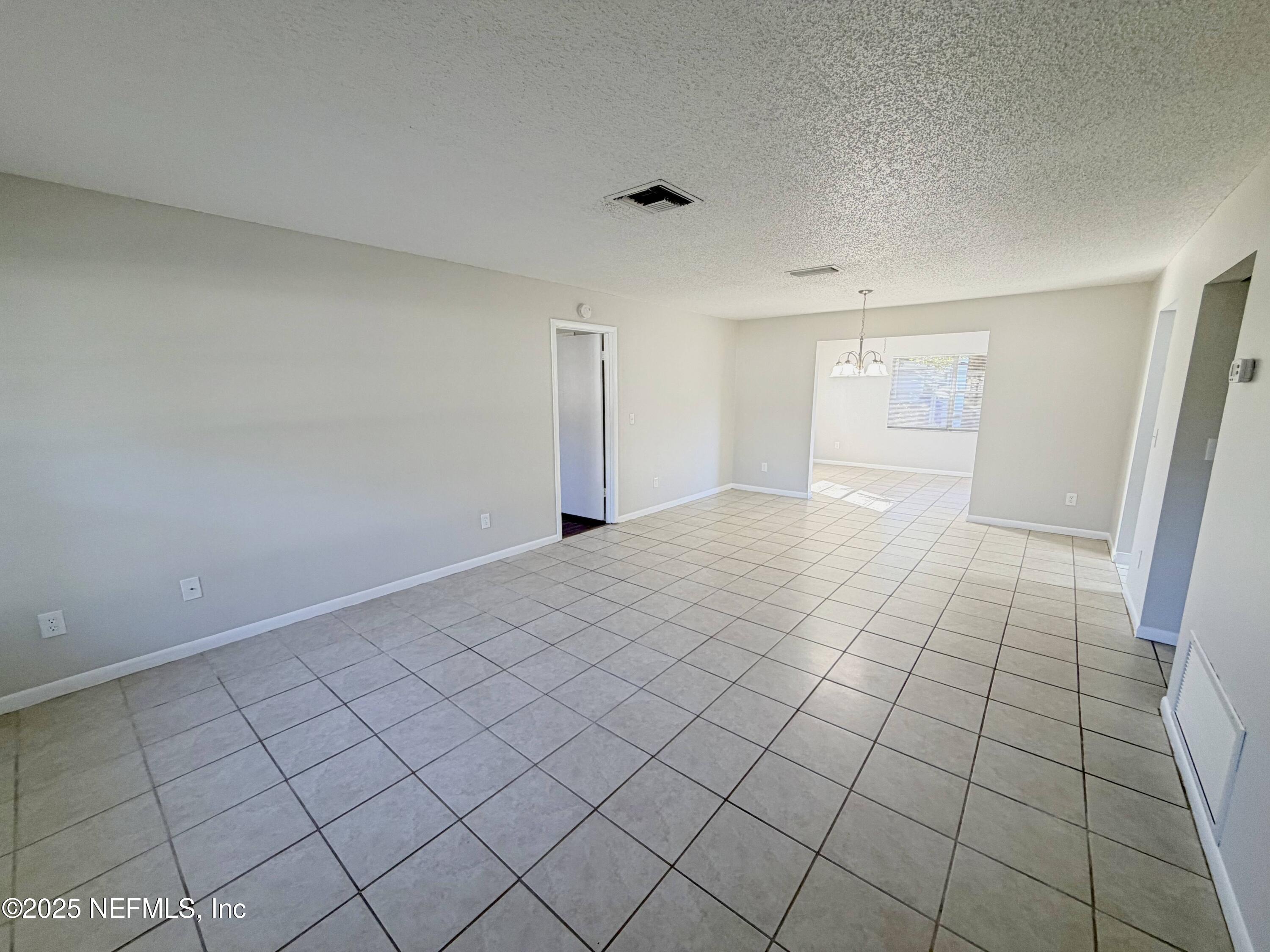 283 Almansa Road St. Augustine, FL 32086 - Photo 2 of 16 a view of an empty room and window