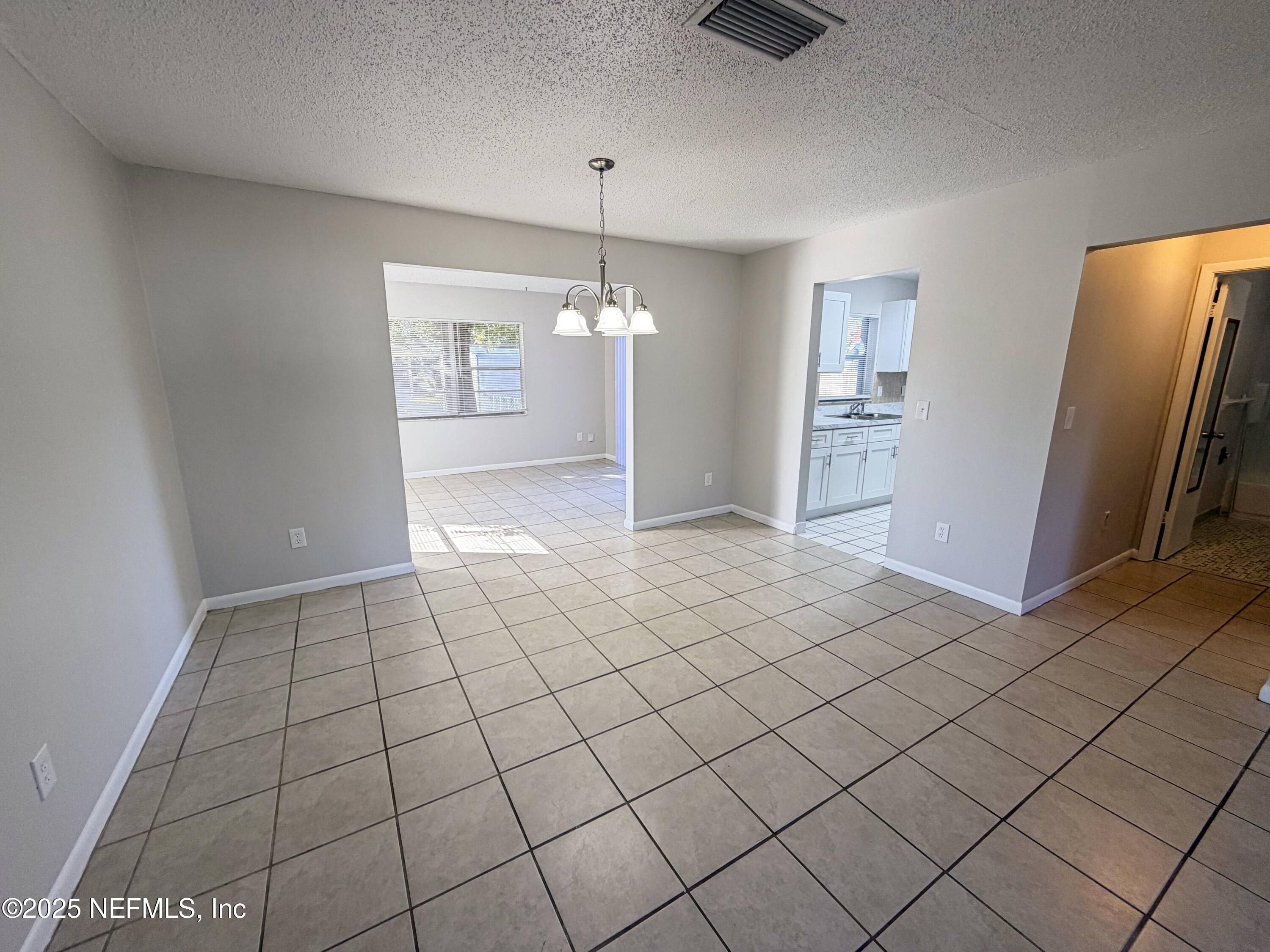 283 Almansa Road St. Augustine, FL 32086 - Photo 3 of 16 a view of a livingroom with a chandelier fan and windows