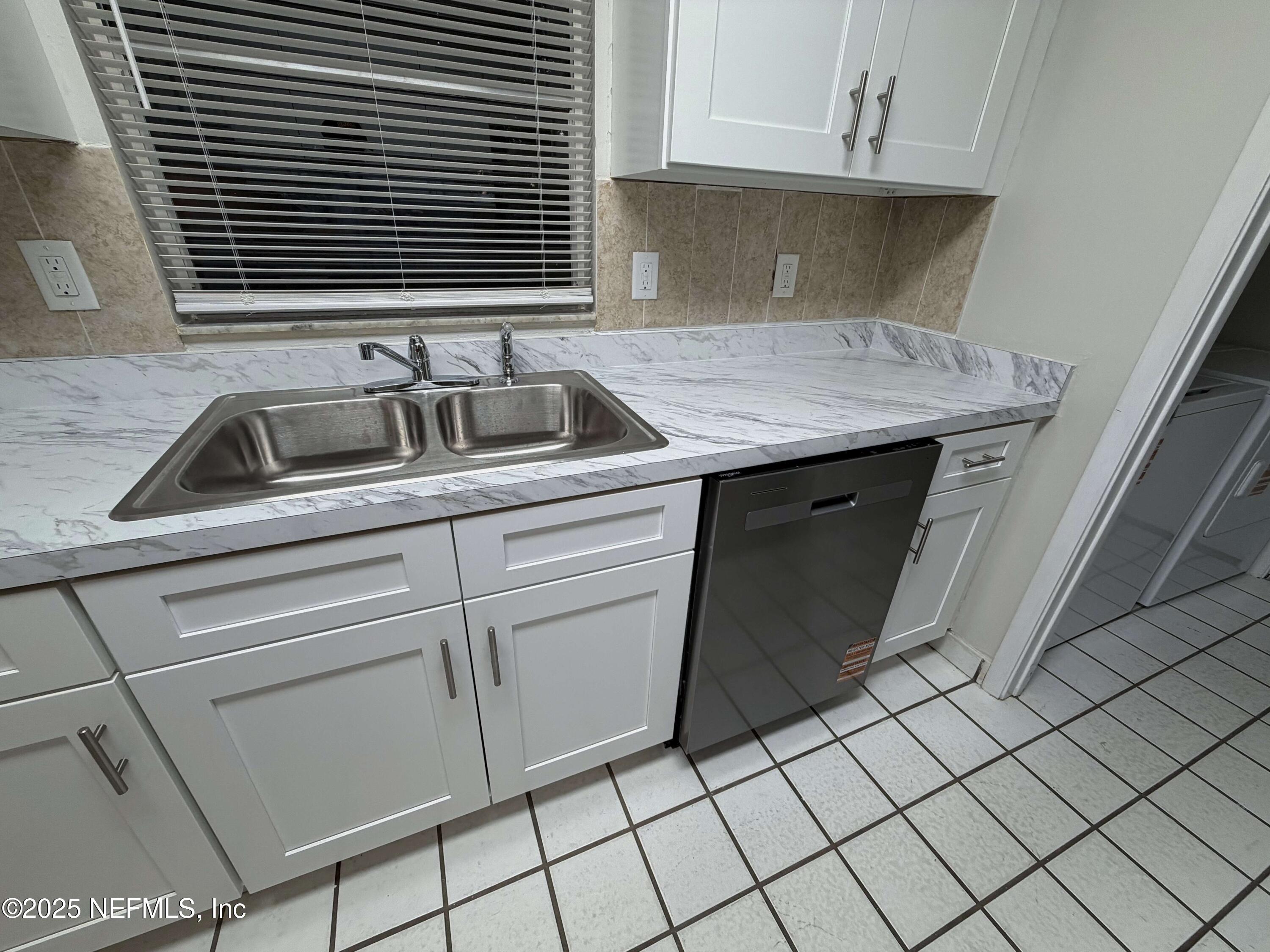 283 Almansa Road St. Augustine, FL 32086 - Photo 8 of 16 a kitchen with a sink and cabinets