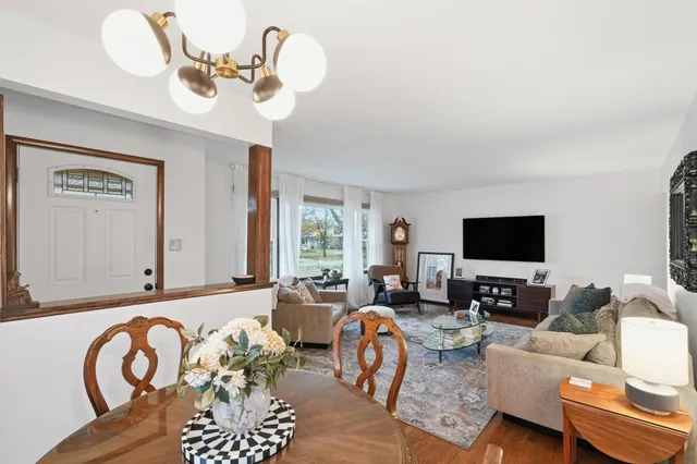 a living room with furniture a flat screen tv and a large window