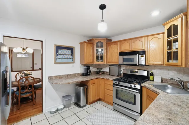 a kitchen with stainless steel appliances kitchen island granite countertop a sink and a stove