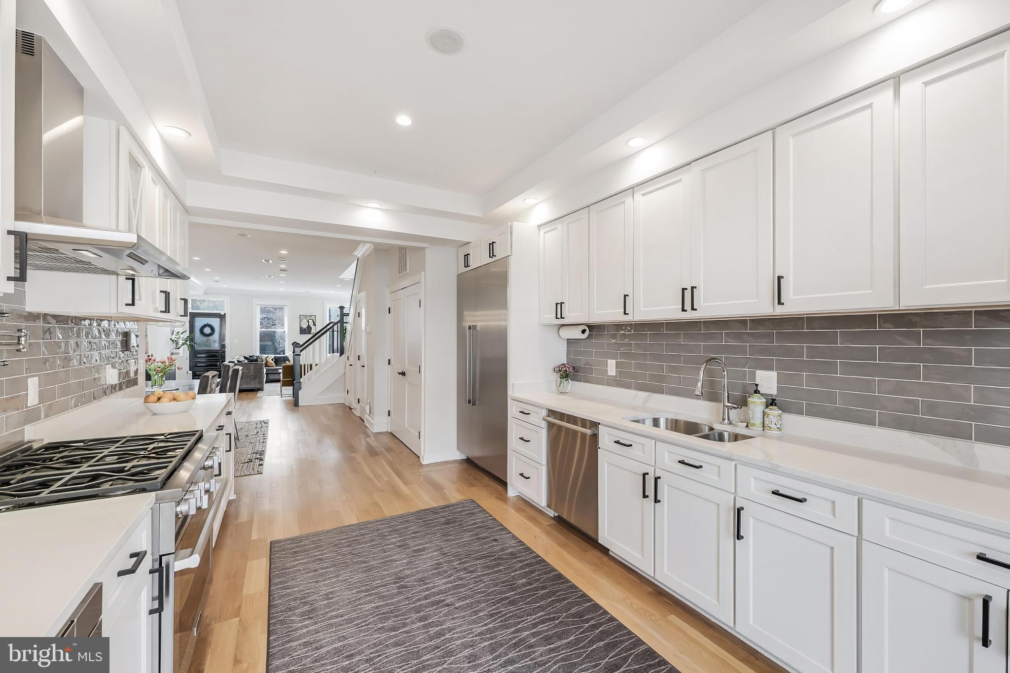 648 F Street Northeast Washington, DC 20002 - Photo 10 of 45 a kitchen with a sink stove and cabinets
