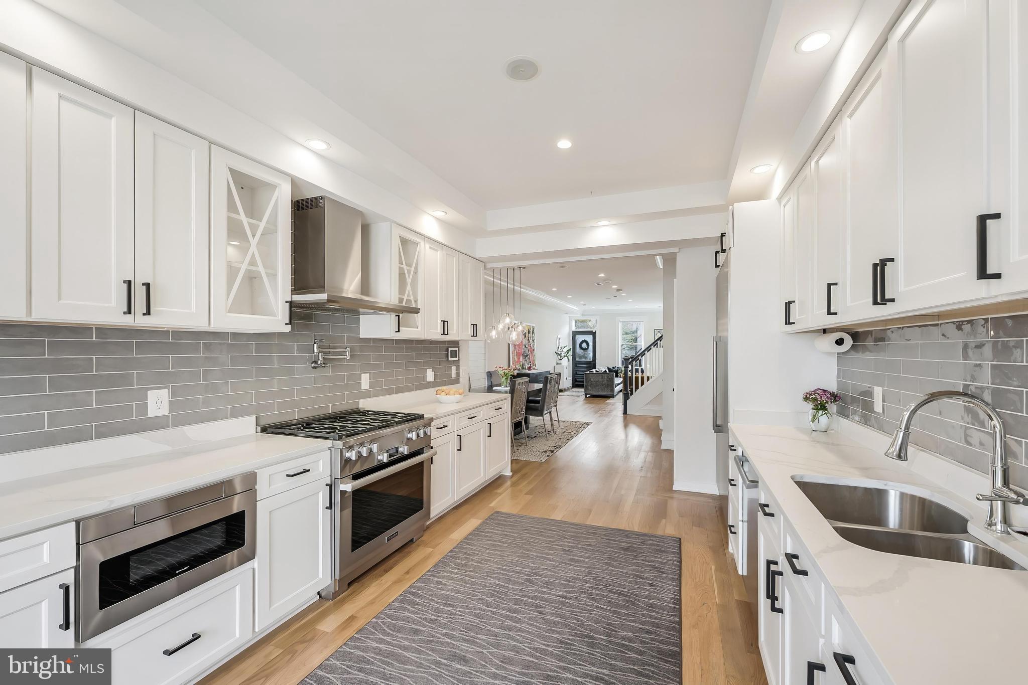 648 F Street Northeast Washington, DC 20002 - Photo 11 of 45 a kitchen with sink stove and cabinets
