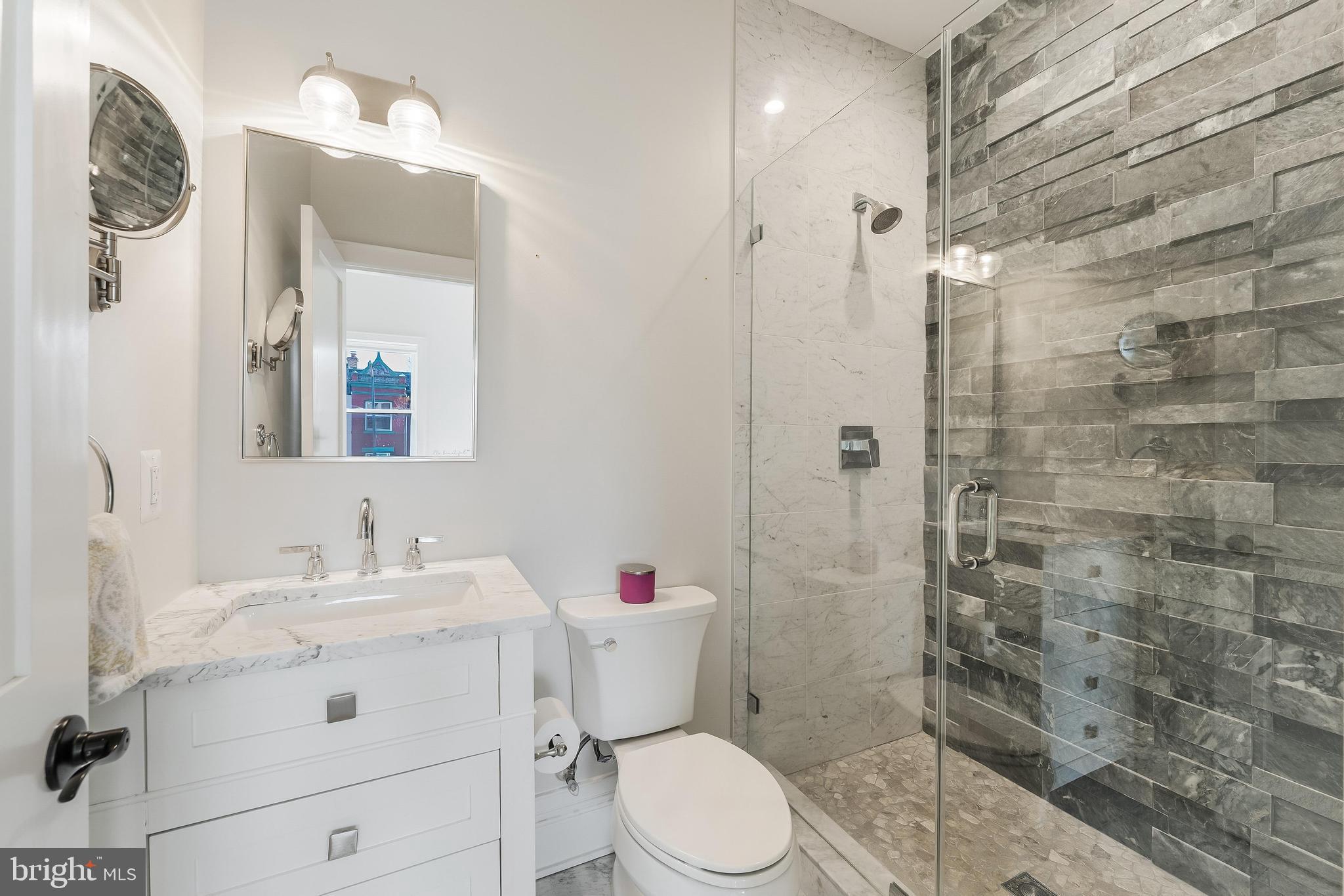 648 F Street Northeast Washington, DC 20002 - Photo 20 of 45 a bathroom with a sink vanity mirror and toilet