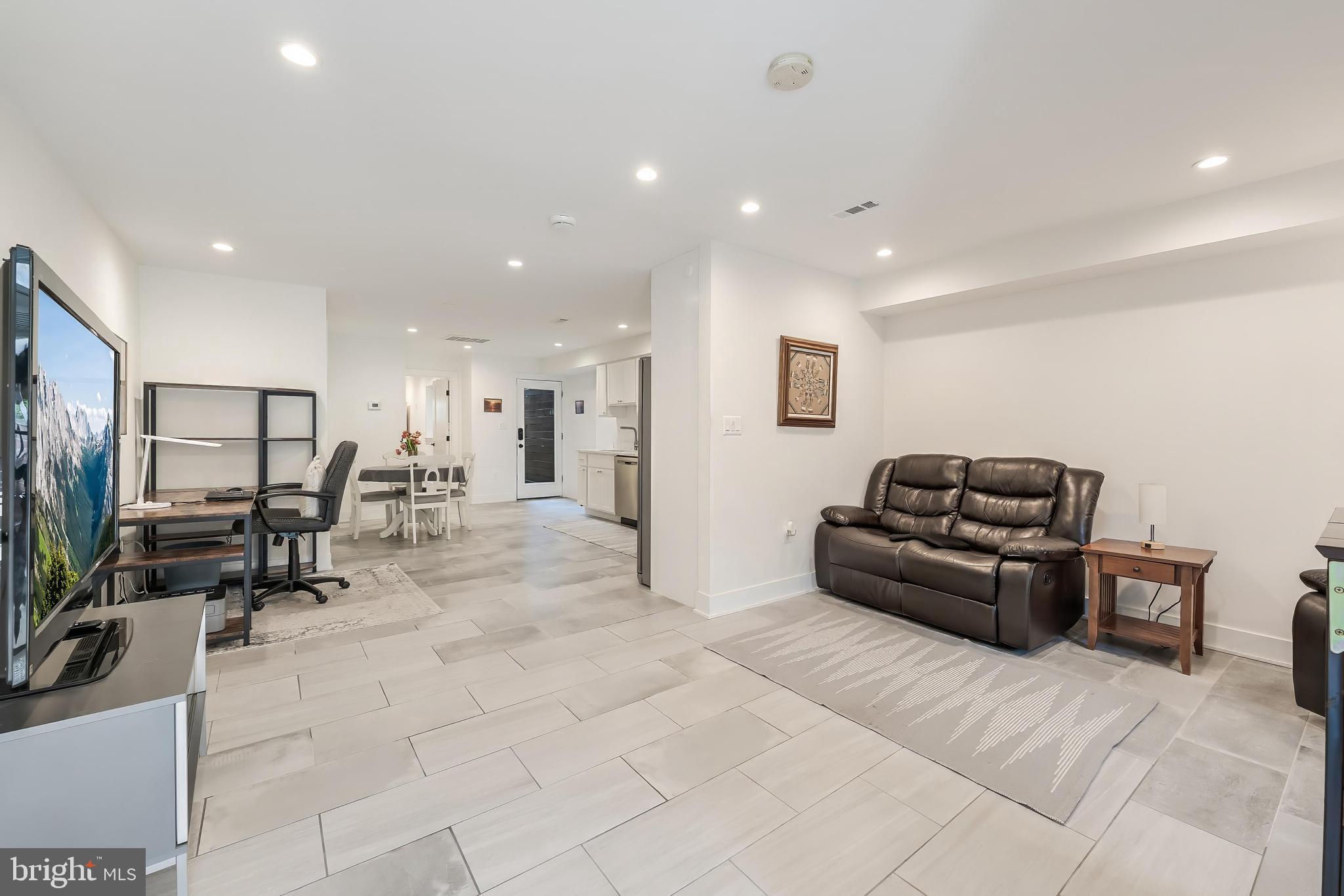 648 F Street Northeast Washington, DC 20002 - Photo 27 of 45 a living room with furniture and a flat screen tv