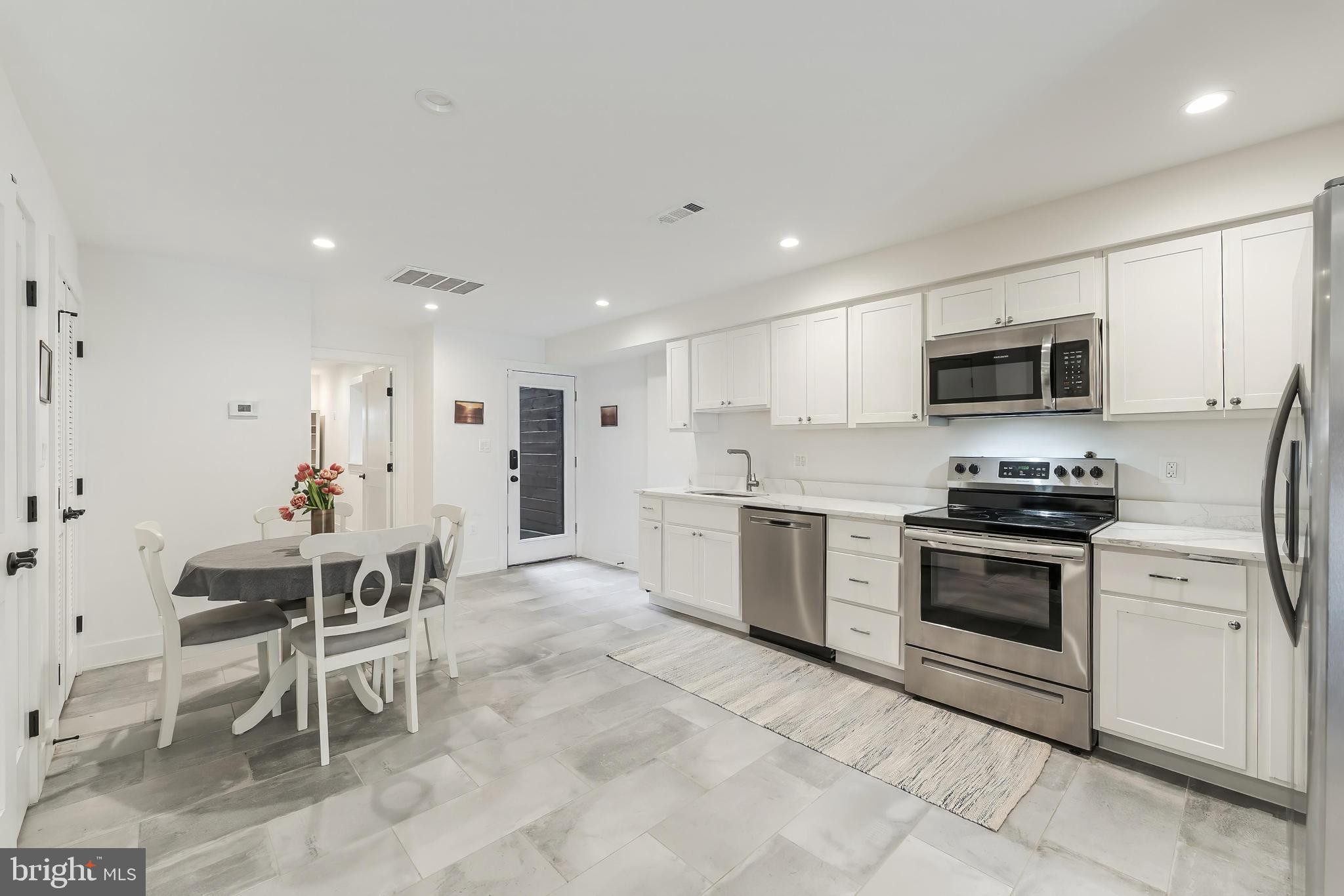 648 F Street Northeast Washington, DC 20002 - Photo 31 of 45 a kitchen with a sink cabinets and stainless steel appliances
