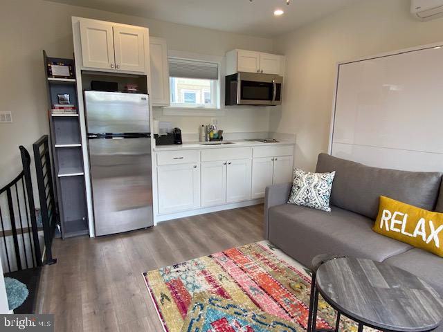 648 F Street Northeast Washington, DC 20002 - Photo 38 of 45 a kitchen with stainless steel appliances refrigerator and microwave