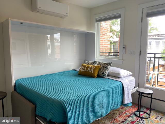 648 F Street Northeast Washington, DC 20002 - Photo 40 of 45 a bedroom with a bed and wooden floor