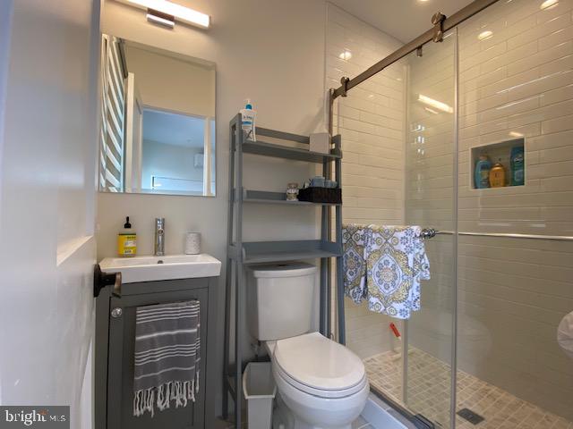 648 F Street Northeast Washington, DC 20002 - Photo 41 of 45 a bathroom with a toilet sink and mirror