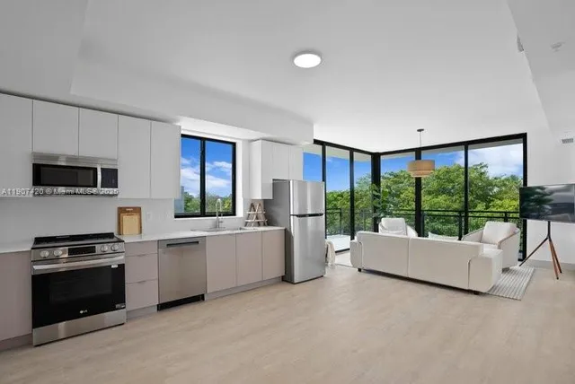 a living room with furniture and a floor to ceiling window