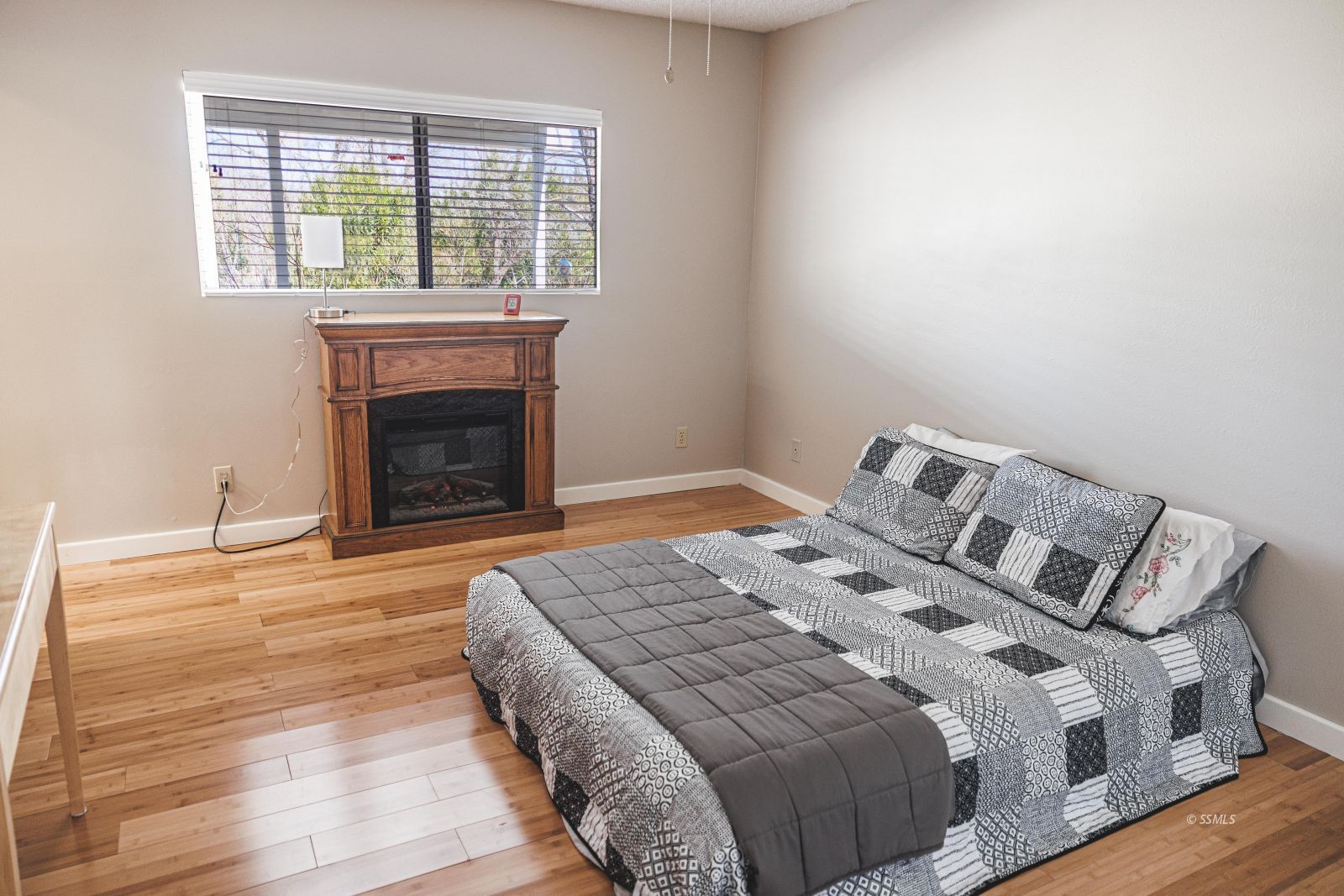 6228 Ridgecrest Boulevard Inyokern, CA 93527 - Photo 18 of 34 a bedroom with a bed and a fireplace