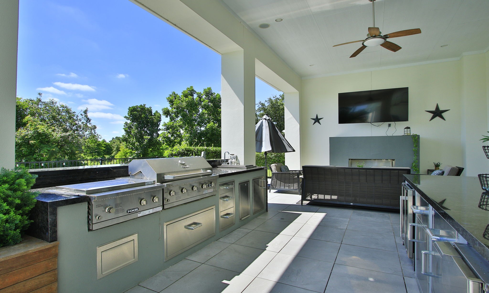 28518 Hoffman Spring Lane Fulshear, TX 77441 - Photo 36 of 50 Impressive and private outdoor living space unlike anything else in the neighborhood featuring the summer kitchen, sitting areas and outdoor shower.
