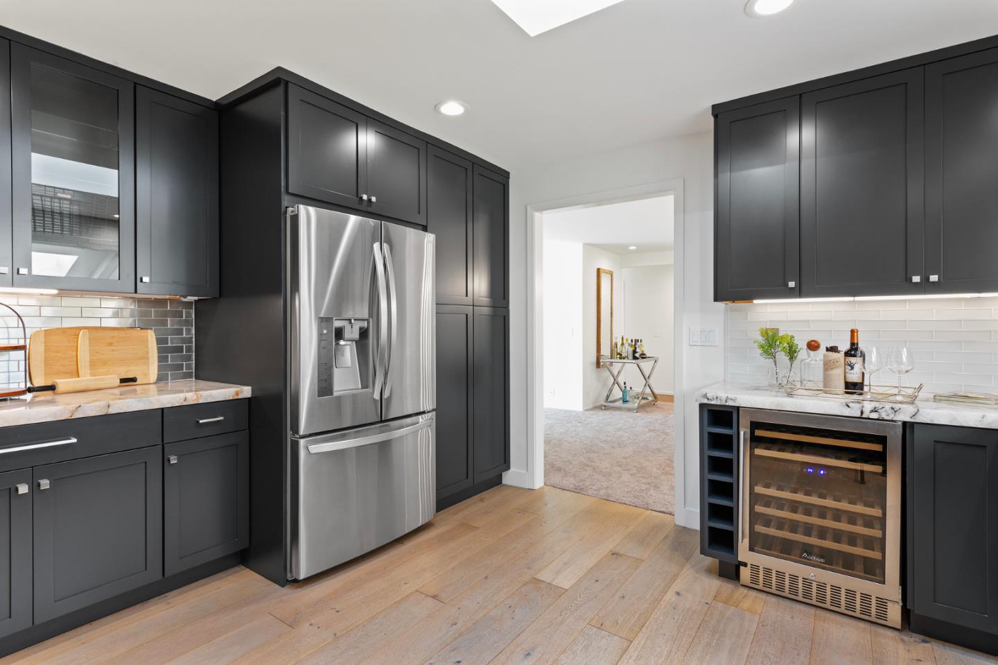 721 Occidental Avenue San Mateo, CA 94402 - Photo 19 of 60 a kitchen with granite countertop a refrigerator and cabinets