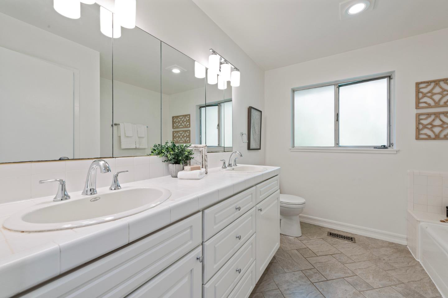 721 Occidental Avenue San Mateo, CA 94402 - Photo 33 of 60 a bathroom with a double vanity sink and a mirror