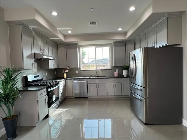 a kitchen with a refrigerator and a sink