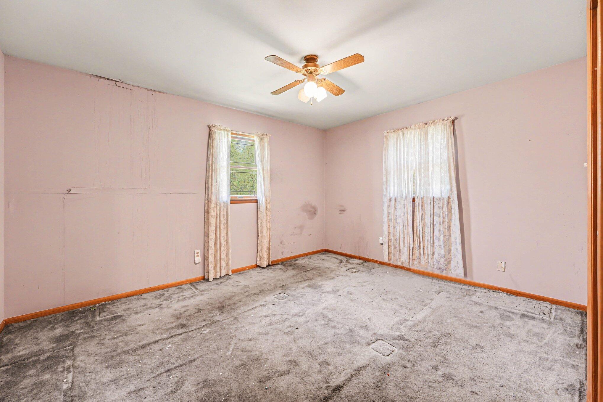 2423 Marshall Place Gary, IN 46404 - Photo 11 of 26 an empty room with windows and fan
