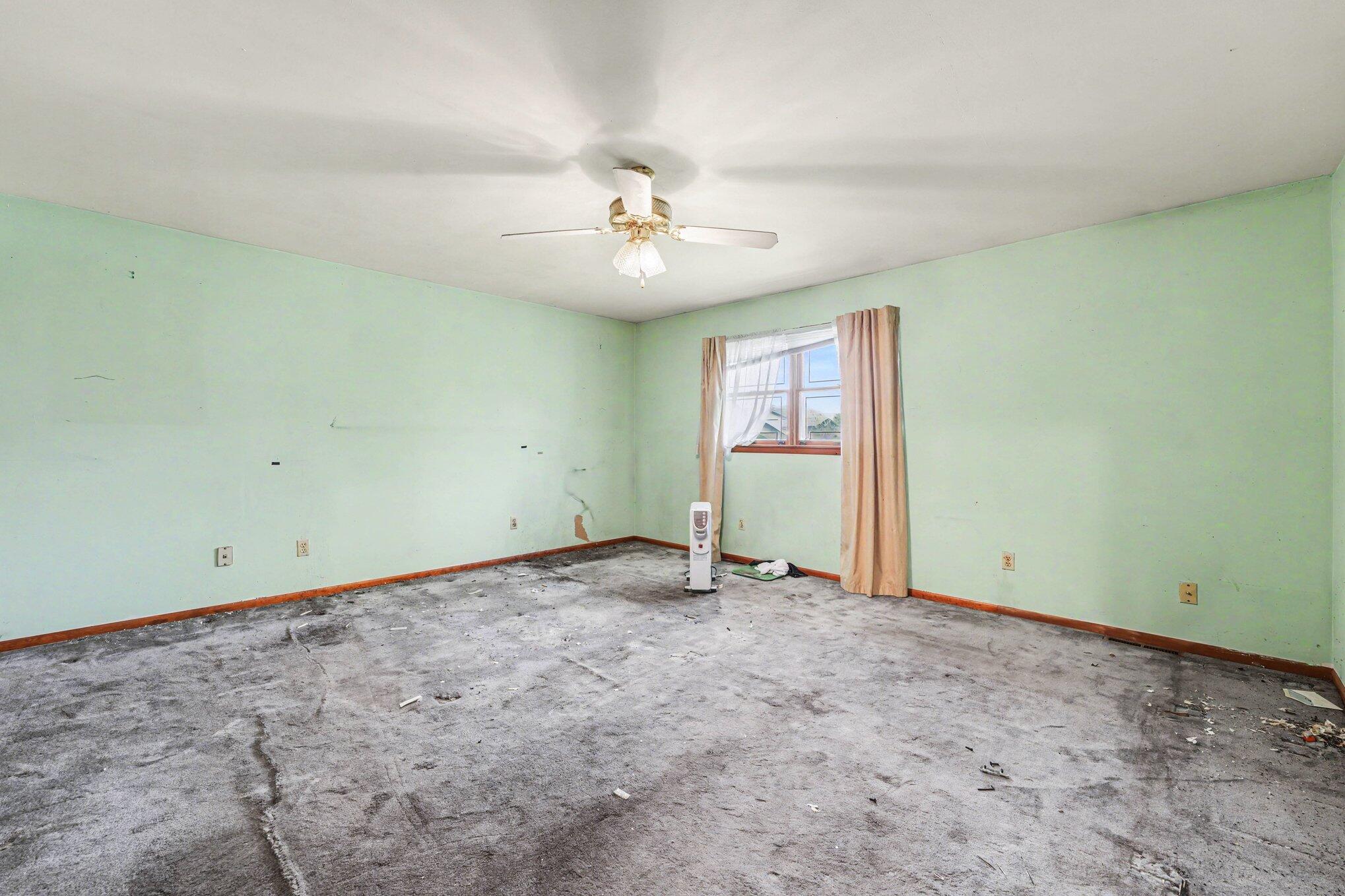 2423 Marshall Place Gary, IN 46404 - Photo 13 of 26 an empty room with chandelier fan and windows