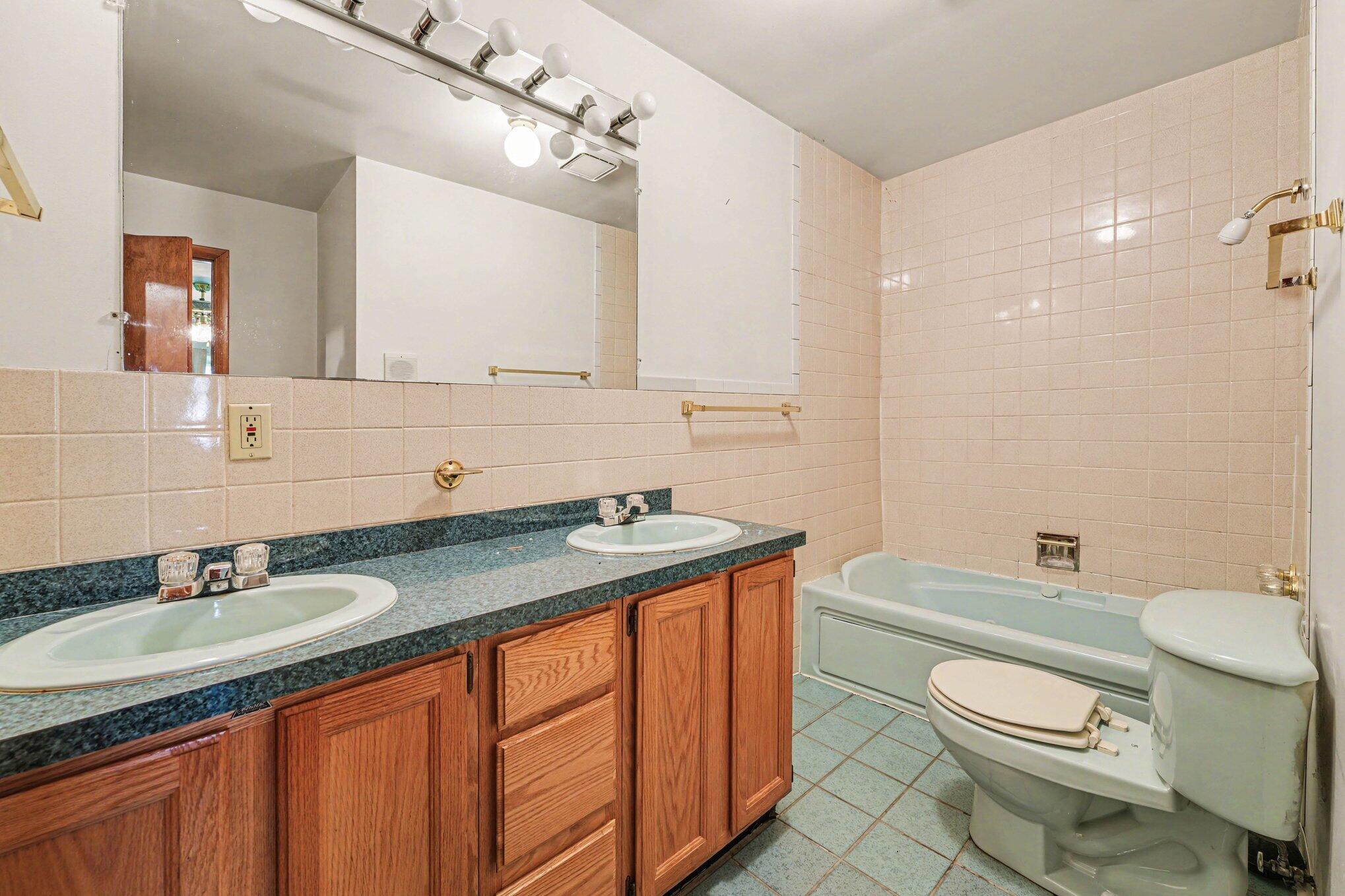 2423 Marshall Place Gary, IN 46404 - Photo 15 of 26 a bathroom with a granite countertop toilet sink and mirror