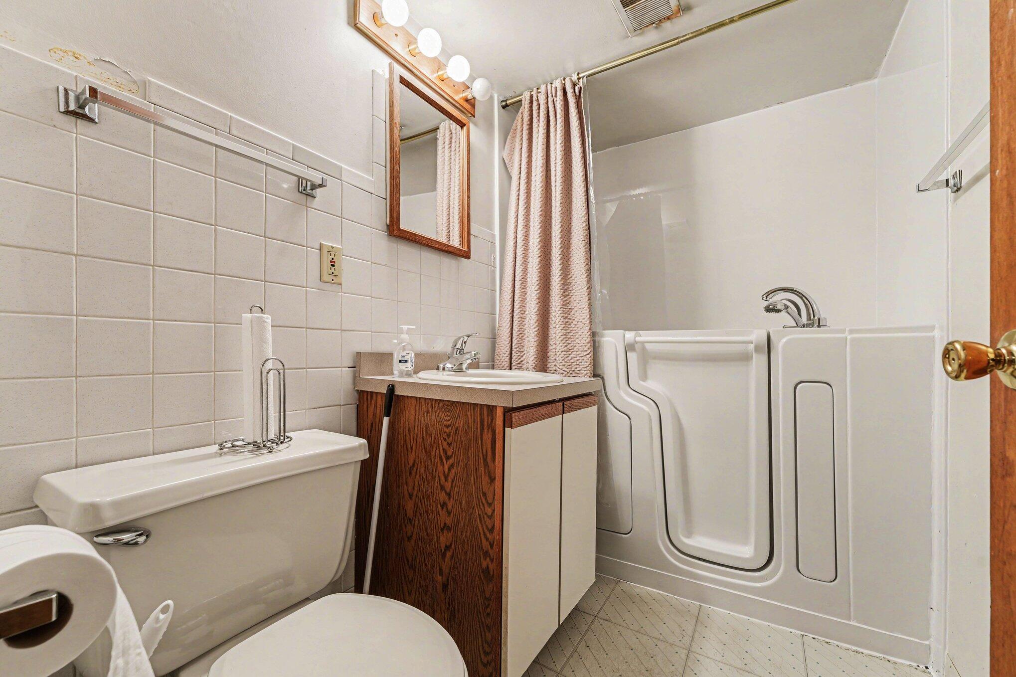 2423 Marshall Place Gary, IN 46404 - Photo 16 of 26 a bathroom with a toilet sink shower and mirror
