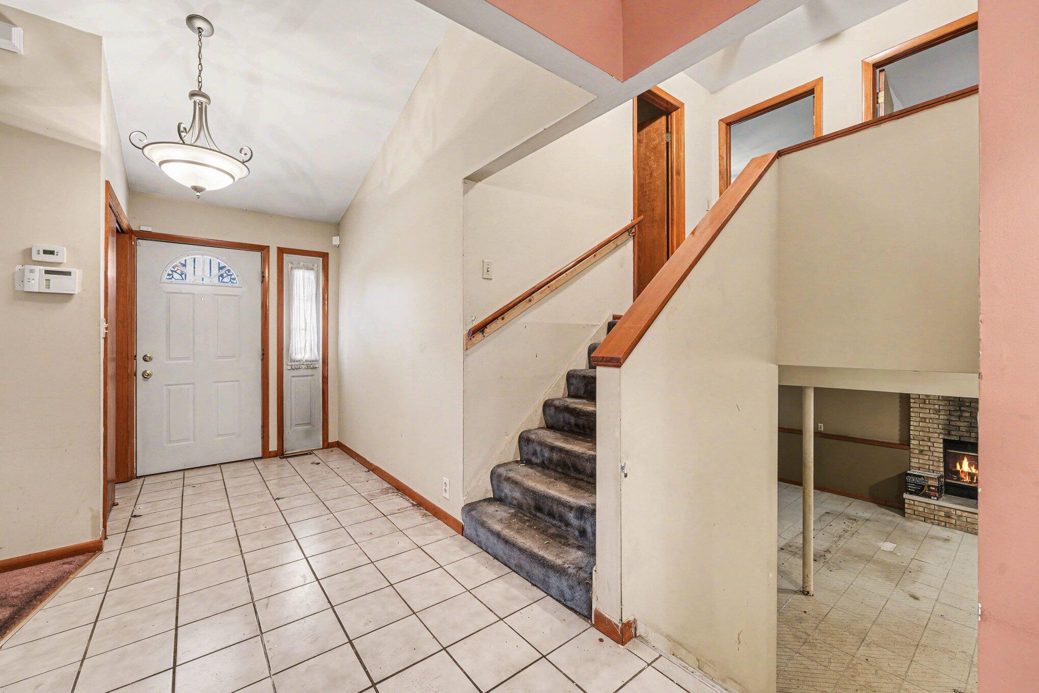 2423 Marshall Place Gary, IN 46404 - Photo 4 of 26 a view of entryway with stairs and a chandelier fan