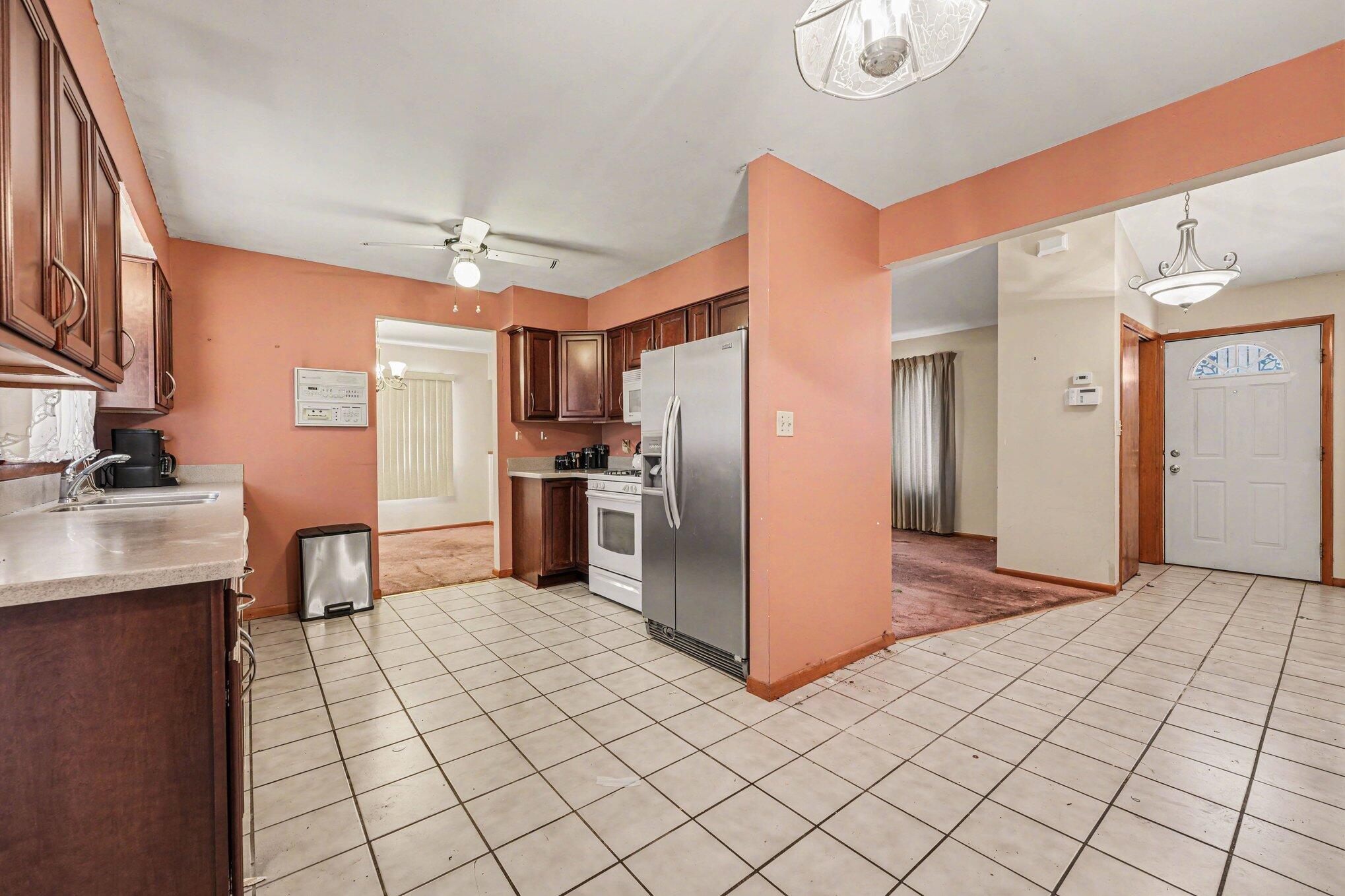 2423 Marshall Place Gary, IN 46404 - Photo 8 of 26 a kitchen with stainless steel appliances a refrigerator and a stove top oven